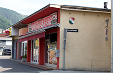 Die Pizzeria Dolce Vita, ein älteres Gebäude, auf der Vorderseite rot mit Verzierungen und italienischen Farben