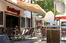 Das Café Liebling Kost.Bar in der Mittergasse, weißes Gebäude mit roten Akzenten und einen weißen Sonnenschutz
